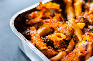 Penne pasta in a tomato and basil sauce with British pork and beef meatballs topped with mature Cheddar cheese