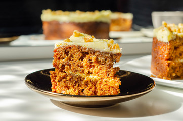 Carrot cake filled and topped with cream cheese buttercream and decorated with walnuts