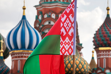 National flag of the Republic of Belarus on the background of St. Basil's Cathedral on red square in the center of Moscow, Russia