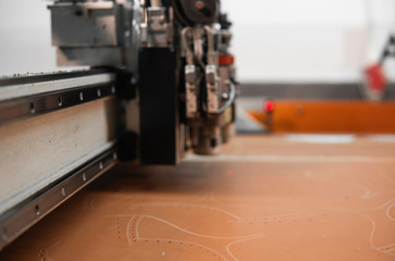 CNC machine for cutting fabrics textile materials and leather. Modern footwear production....