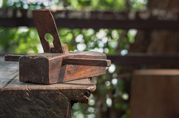 Old carpentry planer, vintage wood planer, on a wooden table.