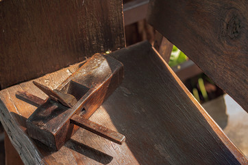Old carpentry planer, vintage wood planer, on a wooden table.