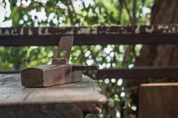 Old carpentry planer, vintage wood planer, on a wooden table.