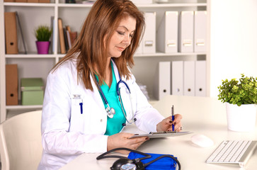 Portrait of happy medical doctor woman in office