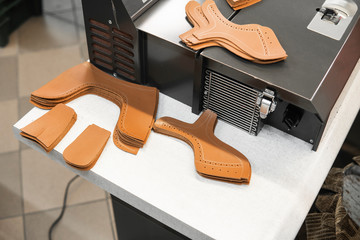 Different forms of leather pieces which will be use for making a shoes on a shoes factory. Prepared, bundled leather parts, used in the production of shoes.