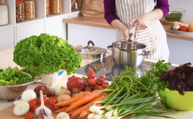 Young Woman Cooking in the kitchen. Healthy Food