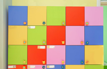 colorful of kid cabinet, wooden furniture for kindergarden or kid's room. changing rooms and lockers of kindergarten . strong rows of color lockers in kindergarden dressing room in pool, children room