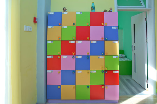 strong rows of color lockers in kindergarden, school, dressing room in pool, children room with texture in white circles .