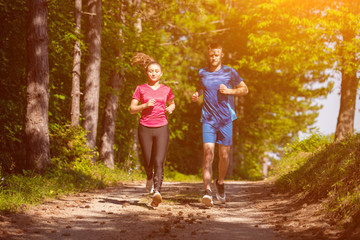 Naklejka na ściany i meble young couple jogging on sunny day at nature