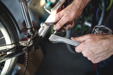 Fixing the bicycle problem in workshop,stock photo
