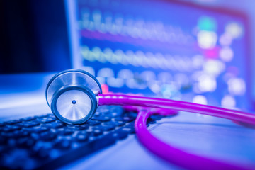 Stethoscope with backdrop of the EKG in a hospital.