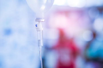 0.9% Normal saline solution (NSS) isolated on blue background and for medical background. Close up image. Drops of saline. 