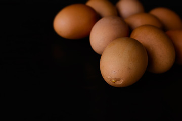 Broken egg  isolated on black background.
