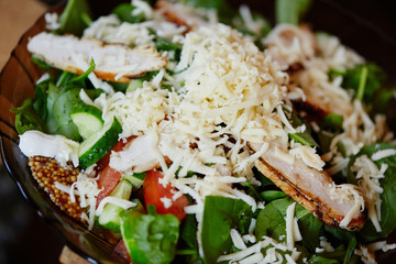 salad with cheese, chicken, spinach, tomato