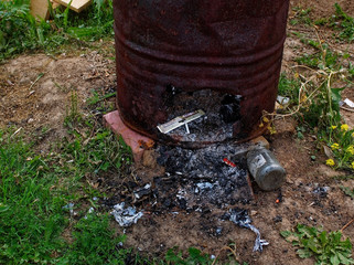 old barrel for burning garbage in the garden, Russia.