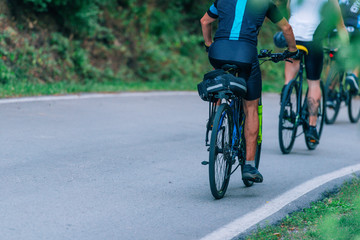 Naklejka premium Group of cyclist rides as fast as they can while competing on a cycling marathon.