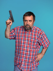 Portrait of a handsome man holding a gun