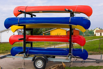 Colorful kayaks loaded on a car trailer