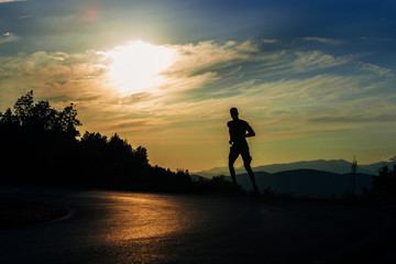 Male athlete fitness runner sprinting fast outside.Trail running concept