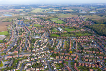 Aerial photo of the town of Castleford in the district of Wakefield in the UK, showing roof top view of typical UK rows of houses and streets.