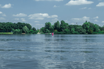Red nautical buoy in the middle of the river