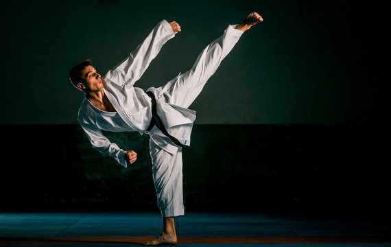 The man in a kimono practicing karate moves