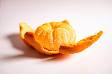 Bright juicy tangerine in the form of a flower isolated on a white background