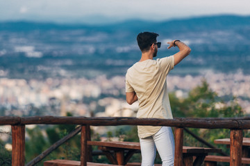 Handsome hipster man enjoying in the city view panorama