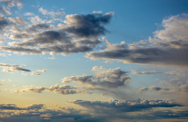 Landscape. Clouds in the blue sky illuminated by the sun