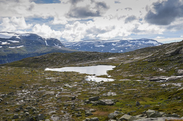 Naklejka na ściany i meble Landscape photo of the trail path to the cliff Trolltunga in the Norwegian mountains.