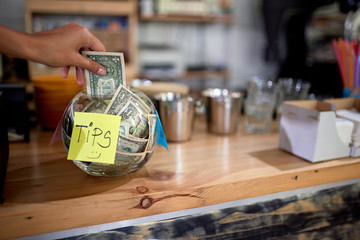 Tips - Money left for a employee,Coffee business concept.