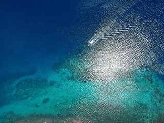 Tropical island and clear blue water from above. Paradise island