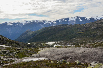 Landscape photo of the trail path to the cliff Trolltunga in the Norwegian mountains.