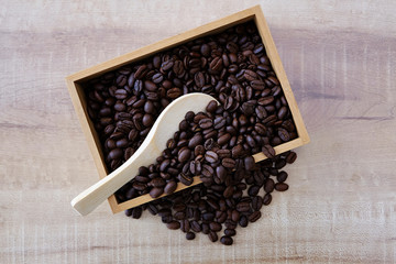 Coffee beans in a wooden spoon