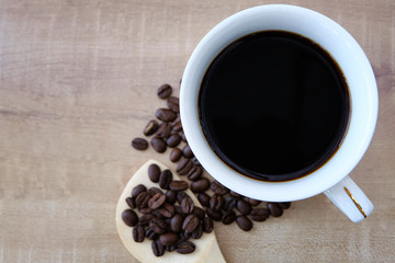 Coffee and coffee beans in a wooden spoon