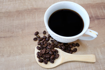 Fototapeta na wymiar Coffee and coffee beans in a wooden spoon
