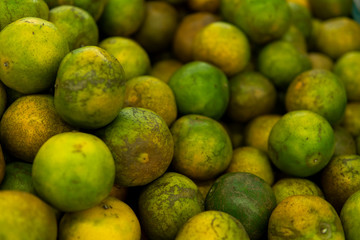 Green fresh whole ripe green tangerine as a texture. Food concept. Tropical and exotic fruits. Healthy and vitamin food concept.