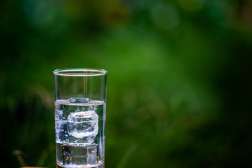 A glass of clean water with ice placed on the table ready to drink