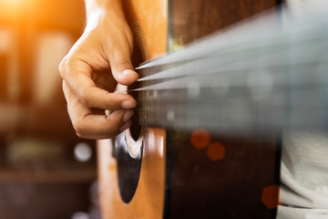 Close up of man hand playing acoustic guitar.
