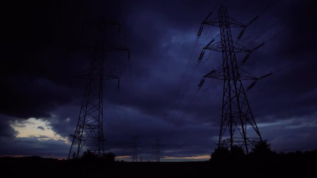 Two pylon standing alone with cloud time-lapse at sunset in 4k resolution