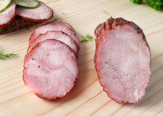 Smoked sausage with vegetables salad on a wooden board