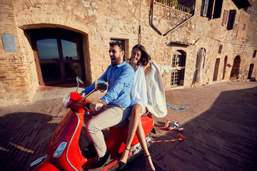 Fototapeta na wymiar .just married man and woman. Young Happy couple riding scooter..