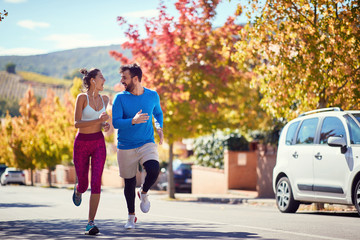 Man and woman enjoying at jogging at city