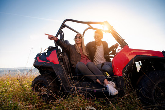 young couple driving a off road buggy car