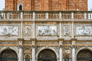 Vintage decoration of Campanile of St Mark, Venice, Italy. Renaissance sculpture in exterior of old building. Historical architecture on San Marco Square in Venice center. Beautiful relief outside.