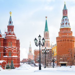 Moscow Kremlin in winter, Russia. It is a top tourist attraction of Moscow. View of Manezhnaya Square in the Moscow center during snowfall. Old Moscow city under snow.