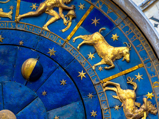 Capricorn astrological sign on ancient clock. Detail of Zodiac wheel with Moon and constellations. Golden symbol of Capricorn on star circle closeup. Concept of astrology and horoscope.