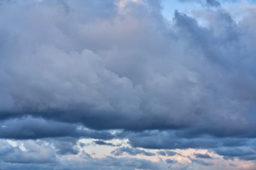 the dark clouds make the sky in black. The rain is coming soon.