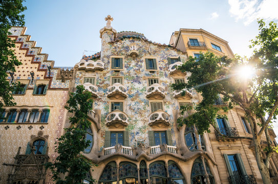 The facade of the house Casa Batllo or House of bones designed by Antoni Gaudi with sunshine at sunset. Barcelona, Catalonia, Spain