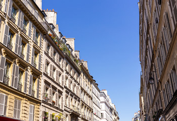 Looking up to typical Parisian buildings facades with blue sky